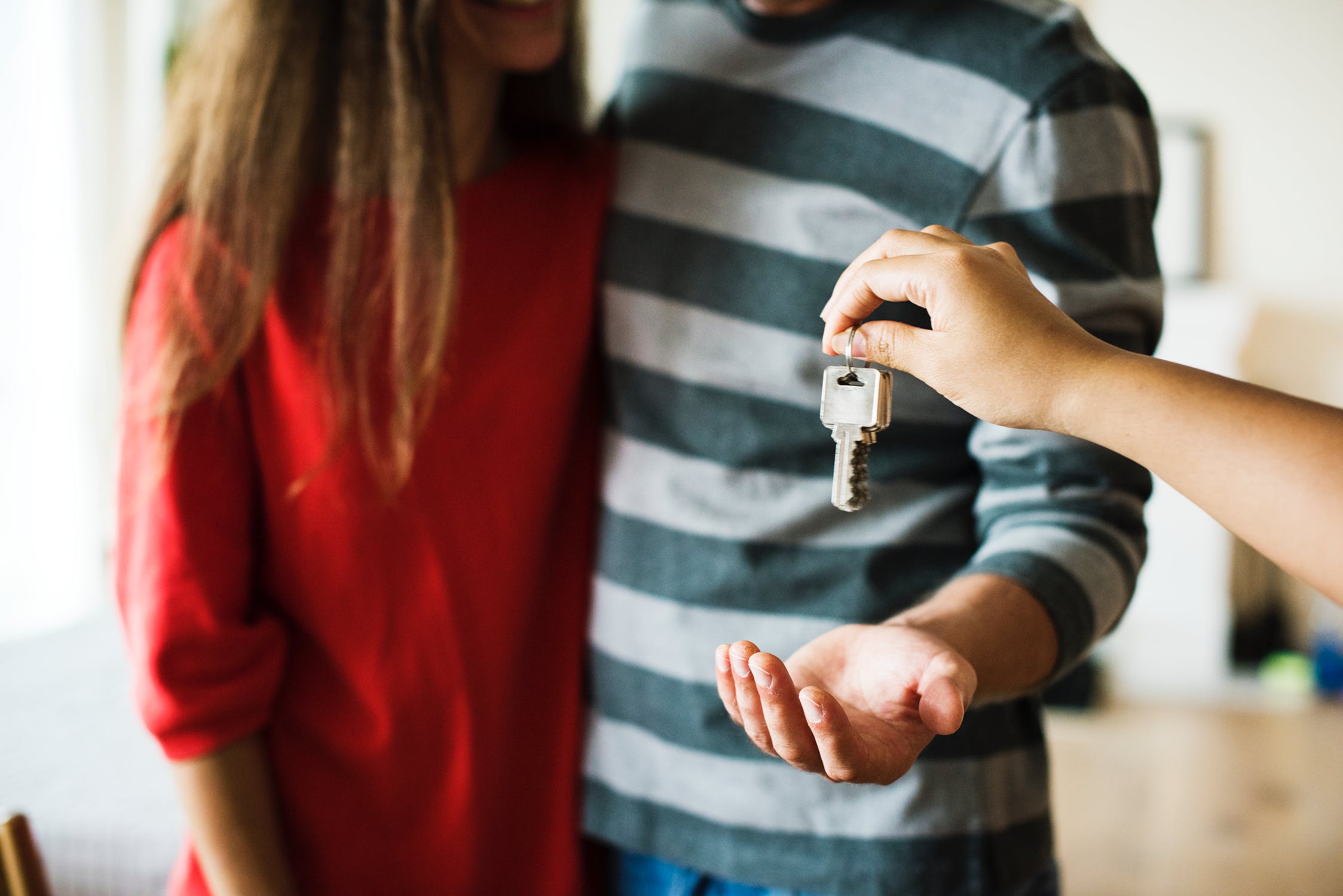 Couple getting the keys to a house